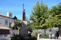 Guadalest Town Square, with Town Hall behind the statue and light feature